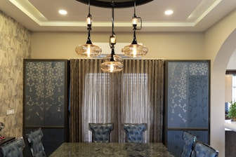 A luxurious dining room with modern lighting.