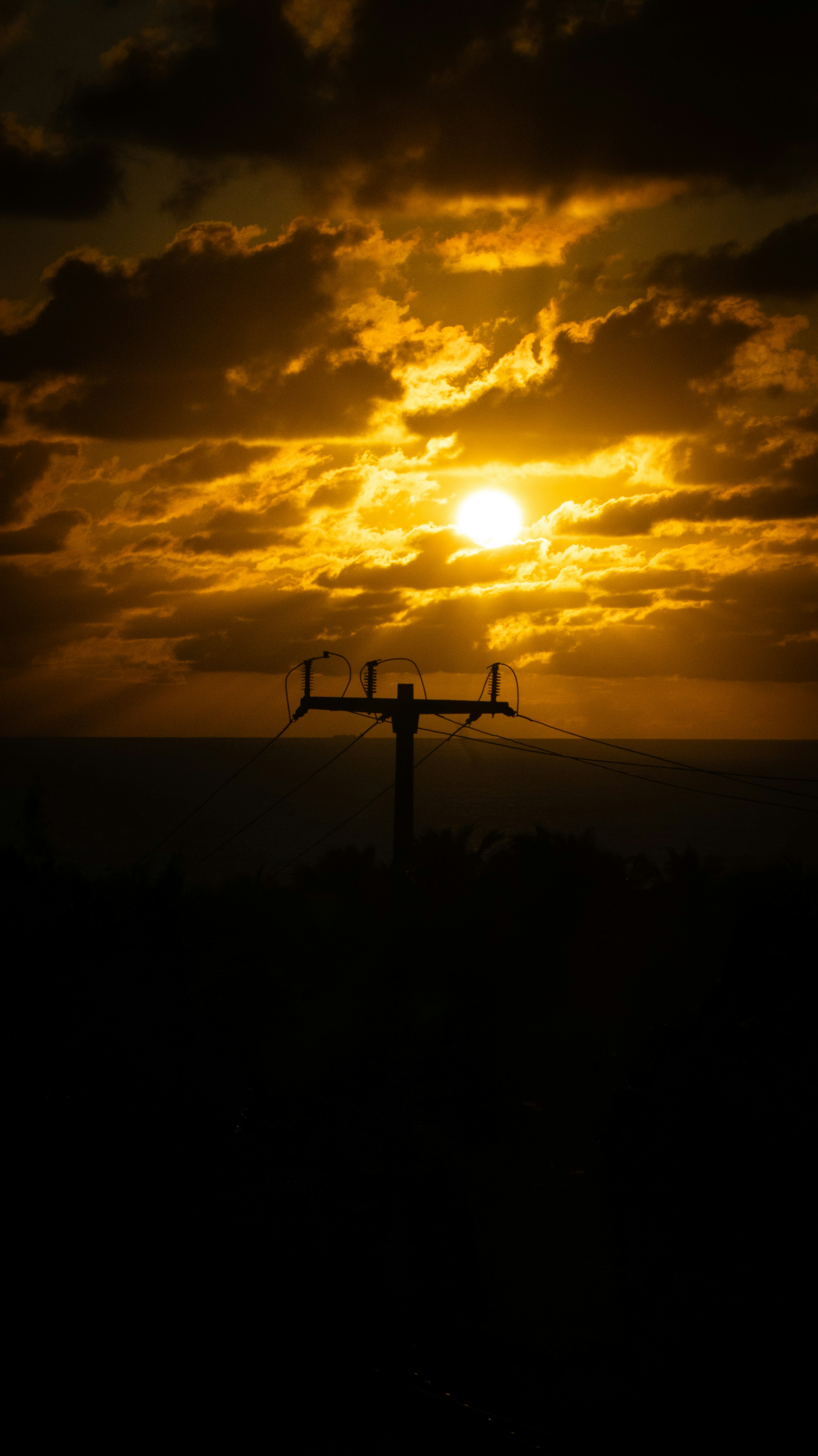 A golden sunset shines through the clouds.