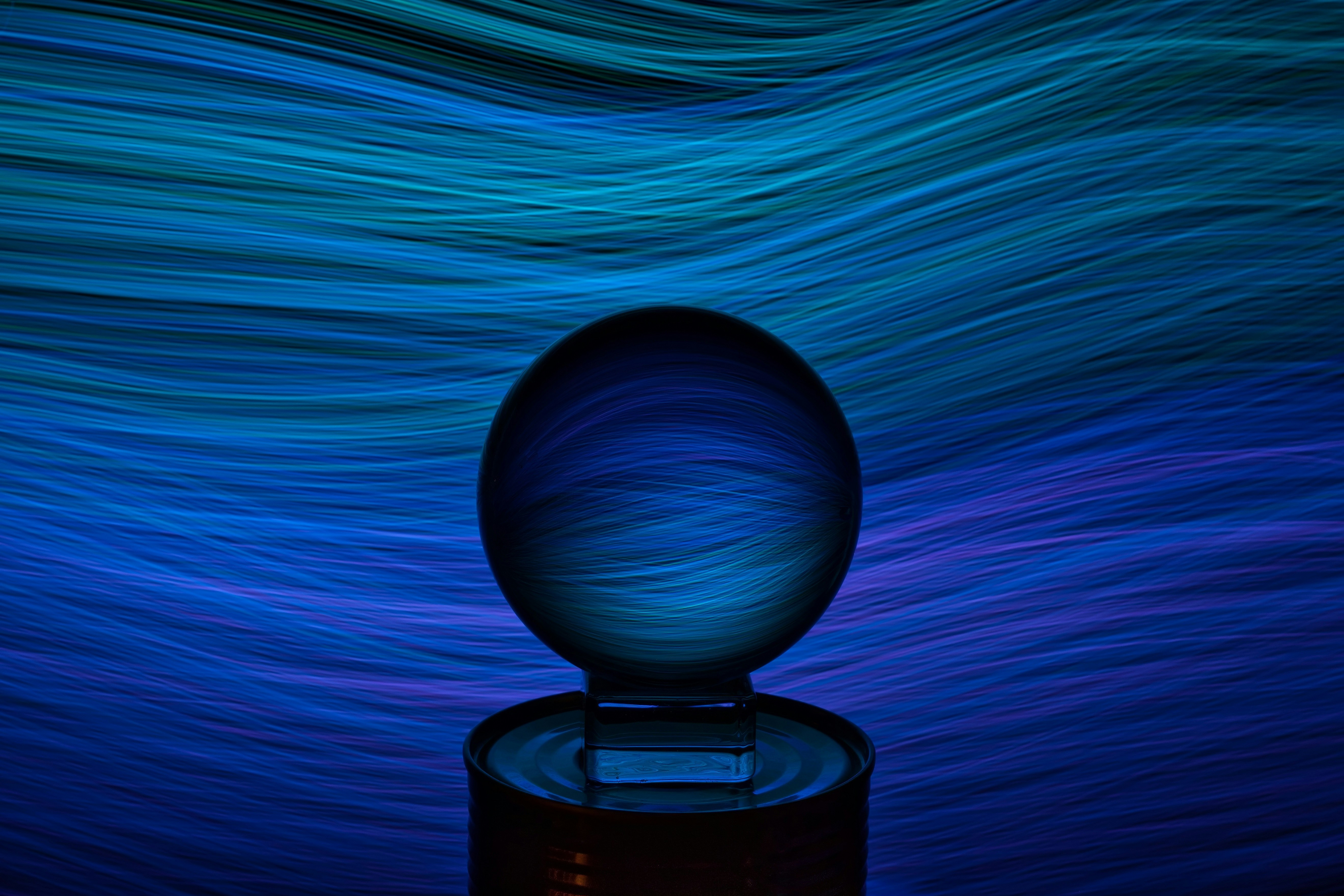 Crystal ball with flowing, blue abstract background