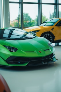 Two lamborghinis are displayed in a showroom.