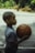 Young boy holds a basketball, ready to play.