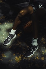 Basketball player rests with ball and sneakers.