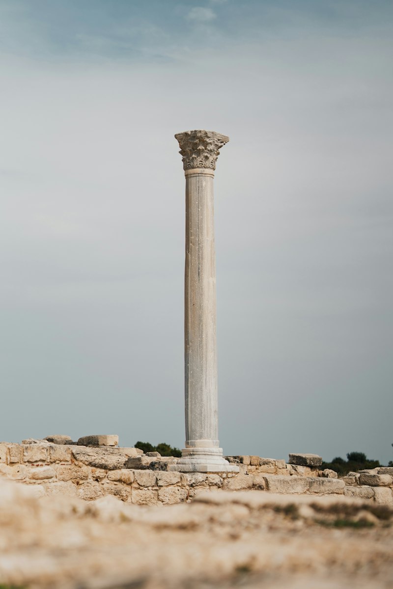 A single ancient column standing amid temple ruins
