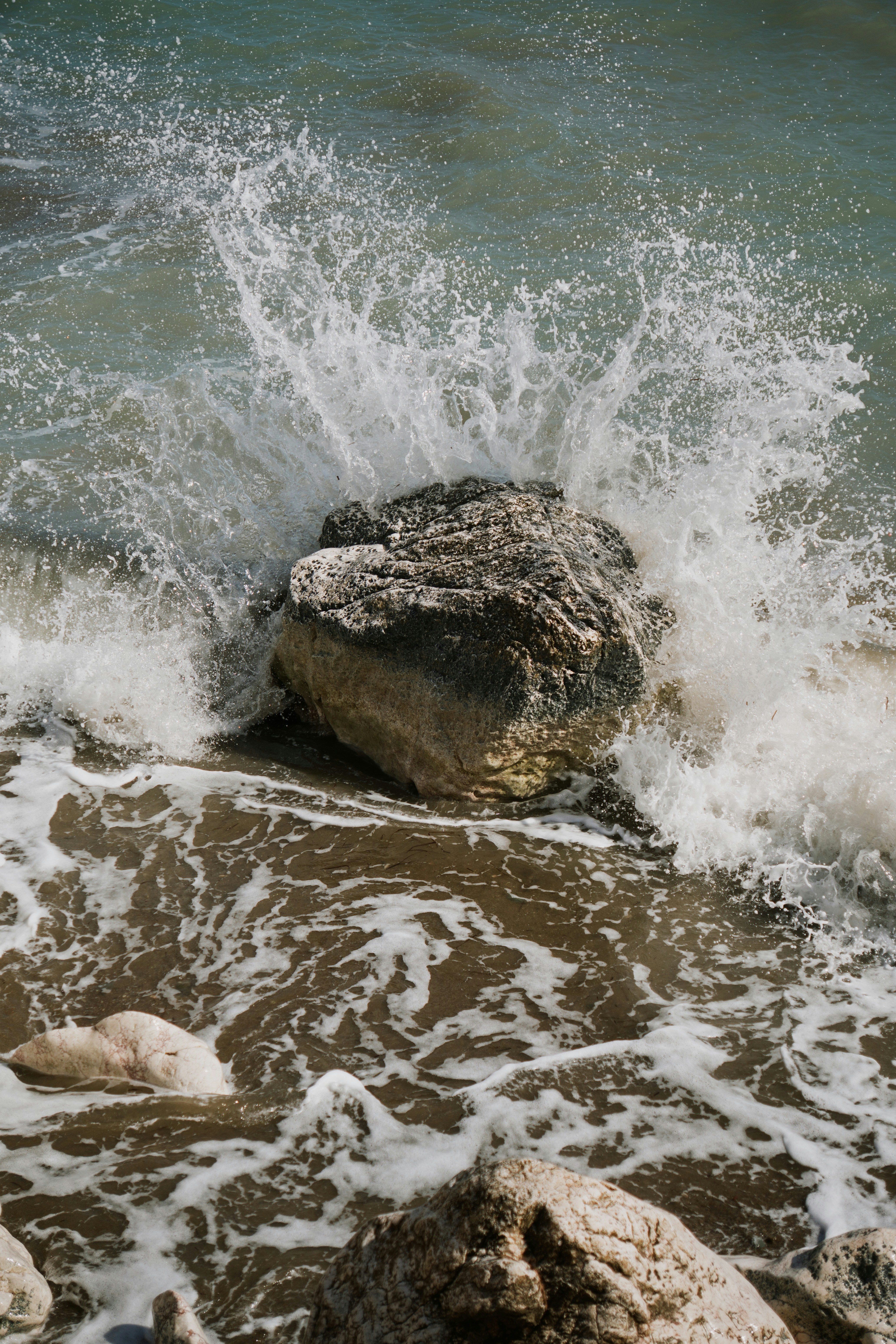 Waves crash against a rocky shore.