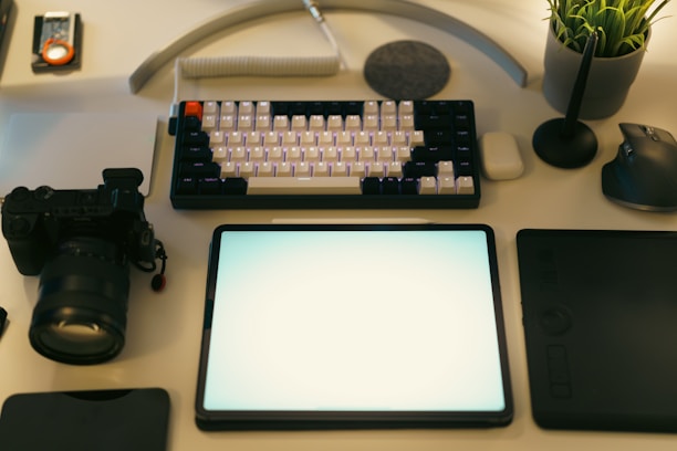 Desk setup with digital camera, keyboard, and other accessories.