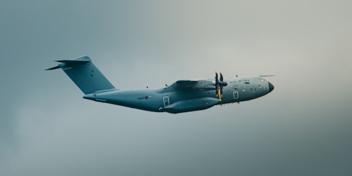 A large military aircraft flies in the sky.