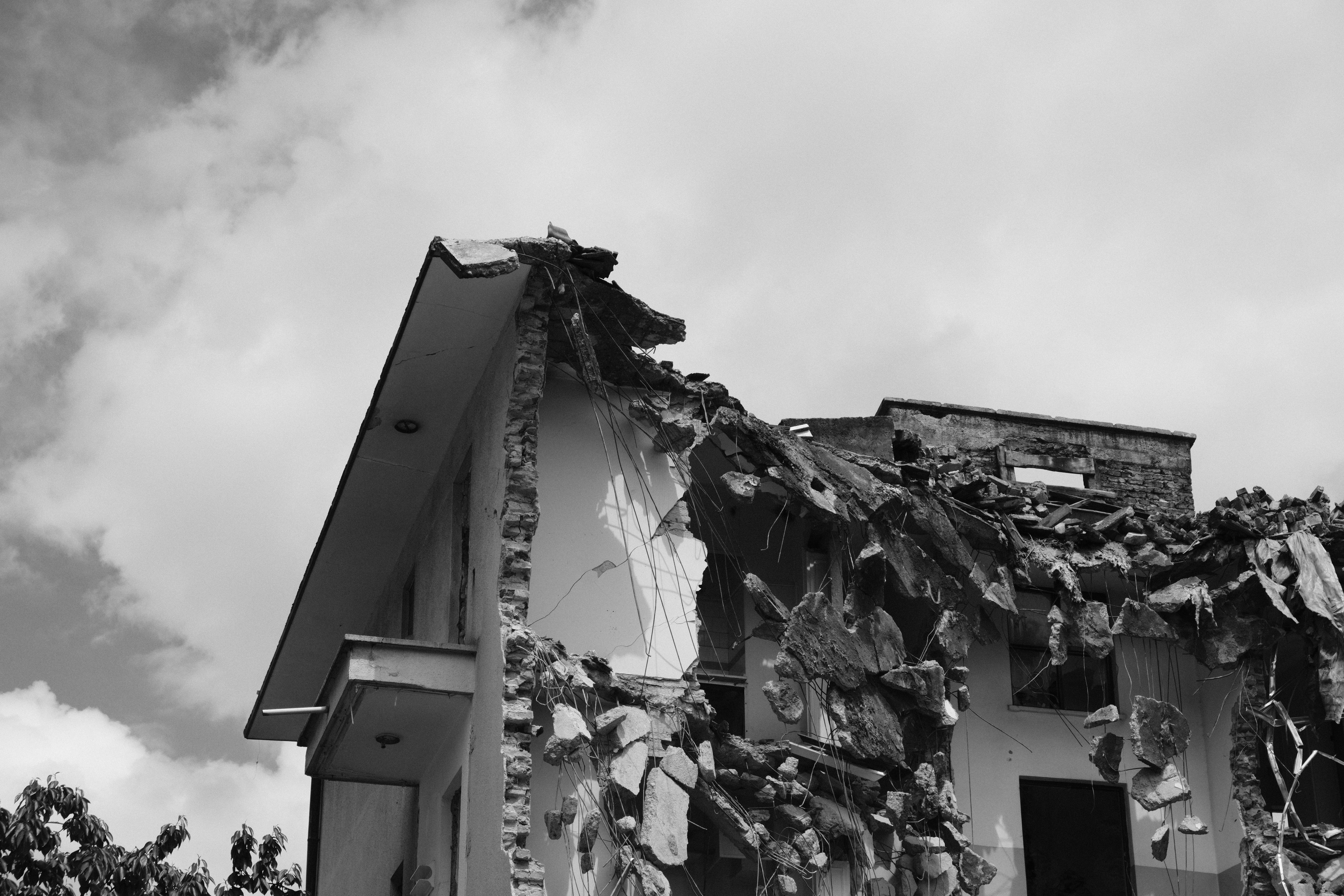 Commercial property damage assessment showing storm damage to building exterior - disputing damage claims in a lawsuit