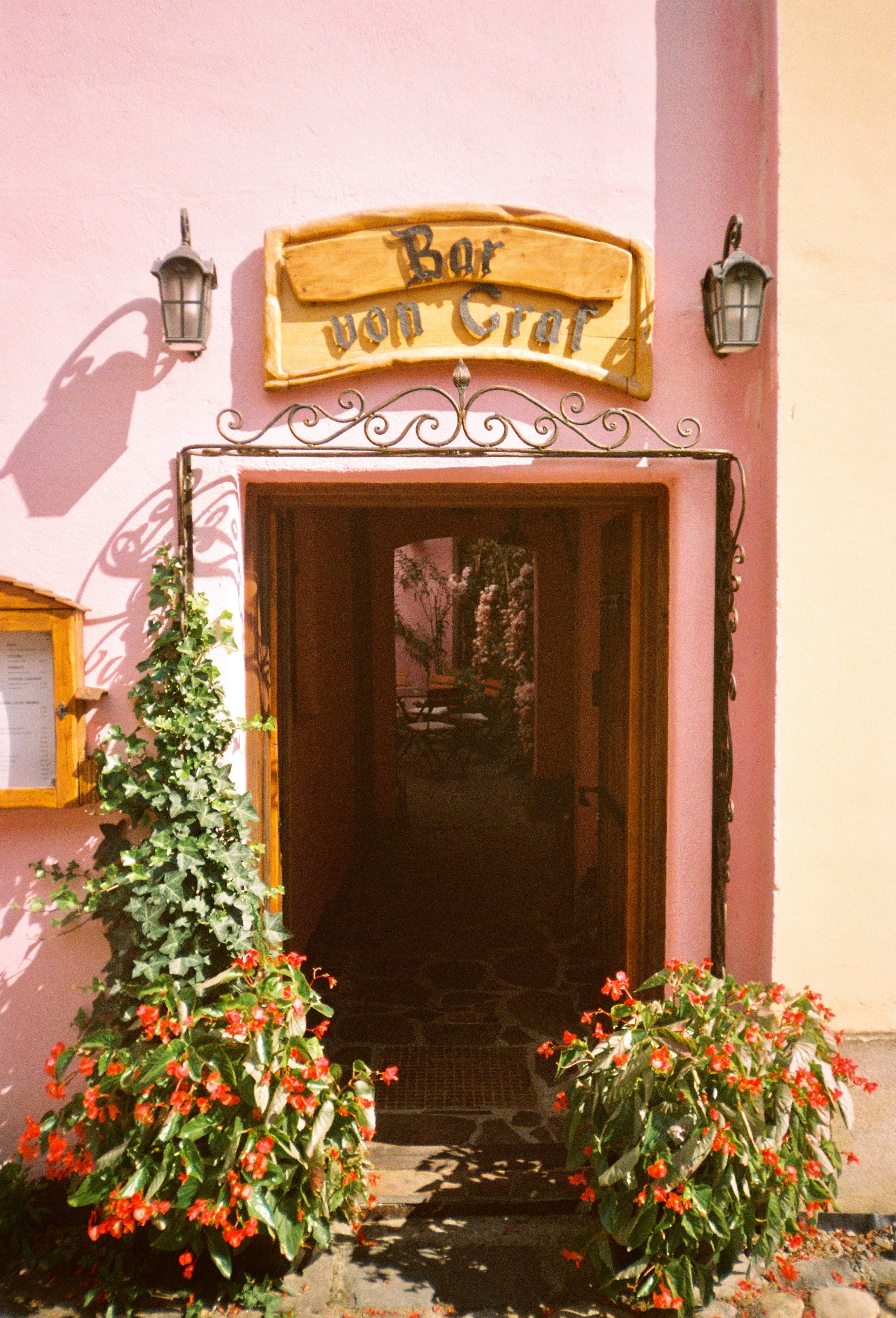 The pink building features a bar entrance.