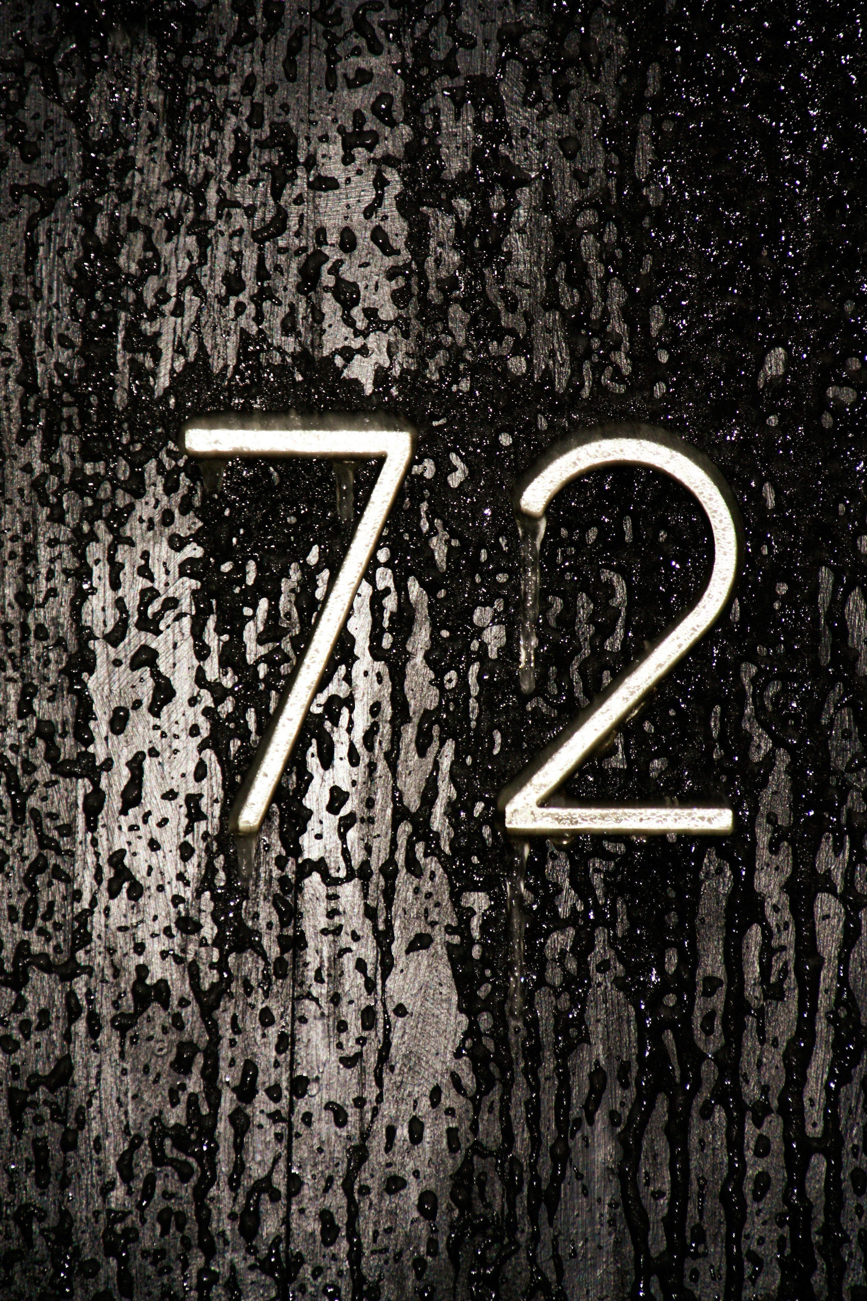 Number seventy-two on a dark, wet surface.