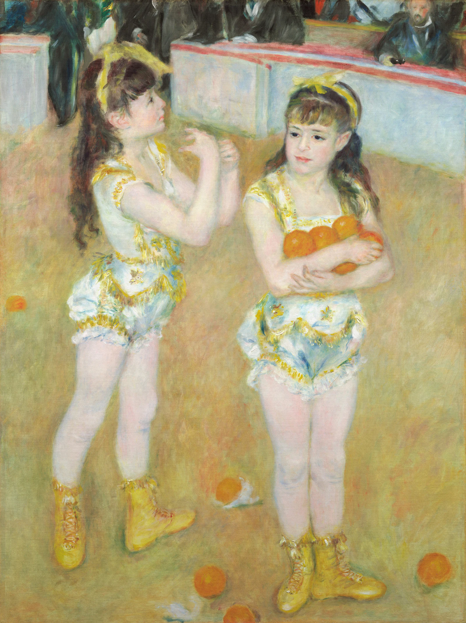 Two young girls in circus costumes holding oranges