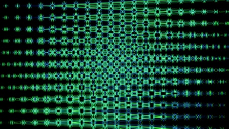 Green, patterned light against a dark background.
