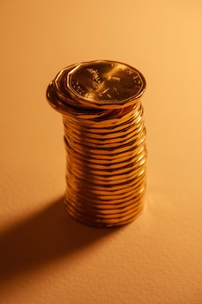 A tall stack of shiny gold coins.