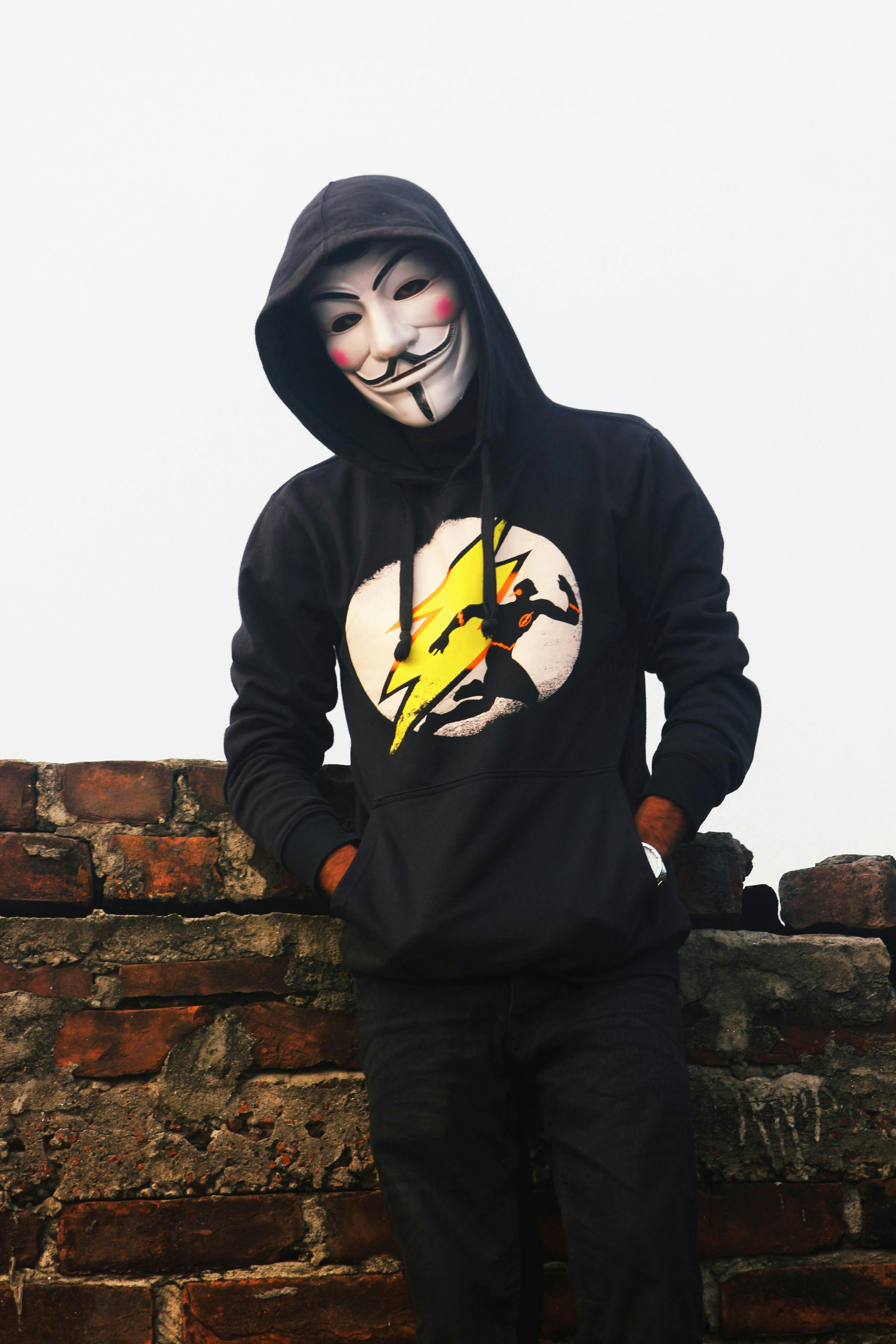 A person wearing an anonymous mask and hoodie.