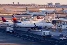 Airplanes are parked at a busy airport terminal.