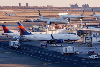 Airplanes are parked at a busy airport terminal.