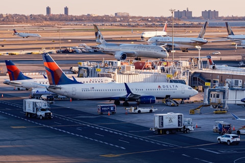 Airplanes are parked at a busy airport terminal.