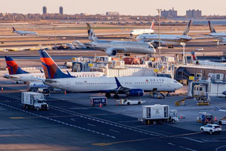 Airplanes are parked at a busy airport terminal.