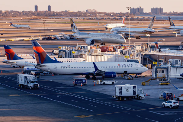Airplanes are parked at a busy airport terminal.