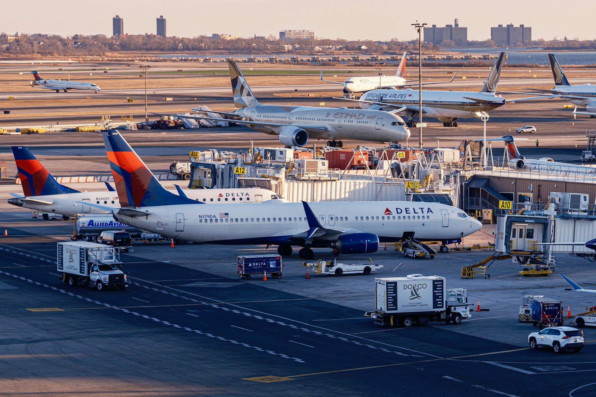 Airplanes are parked at a busy airport terminal.