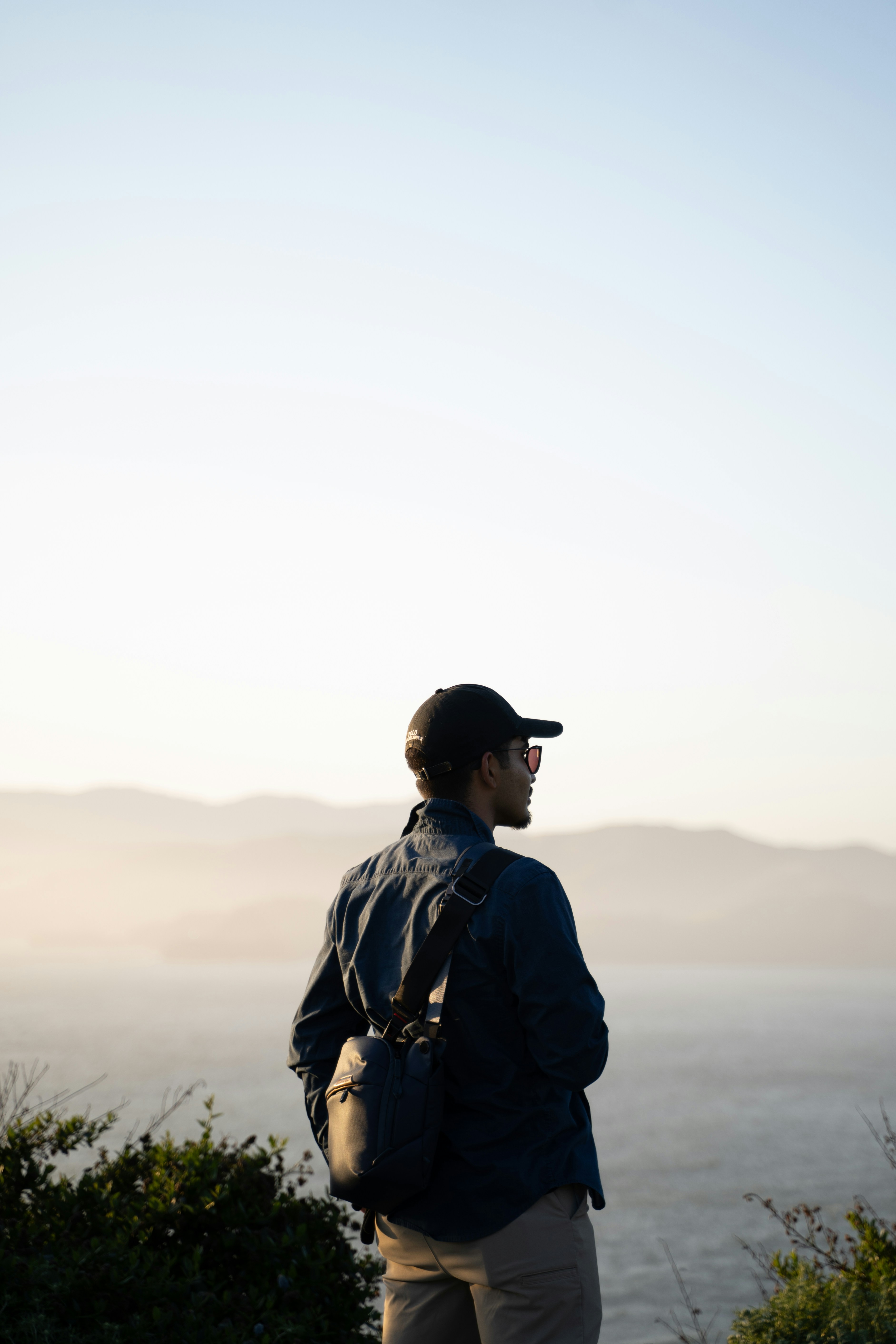 A man overlooks a landscape with mountains.