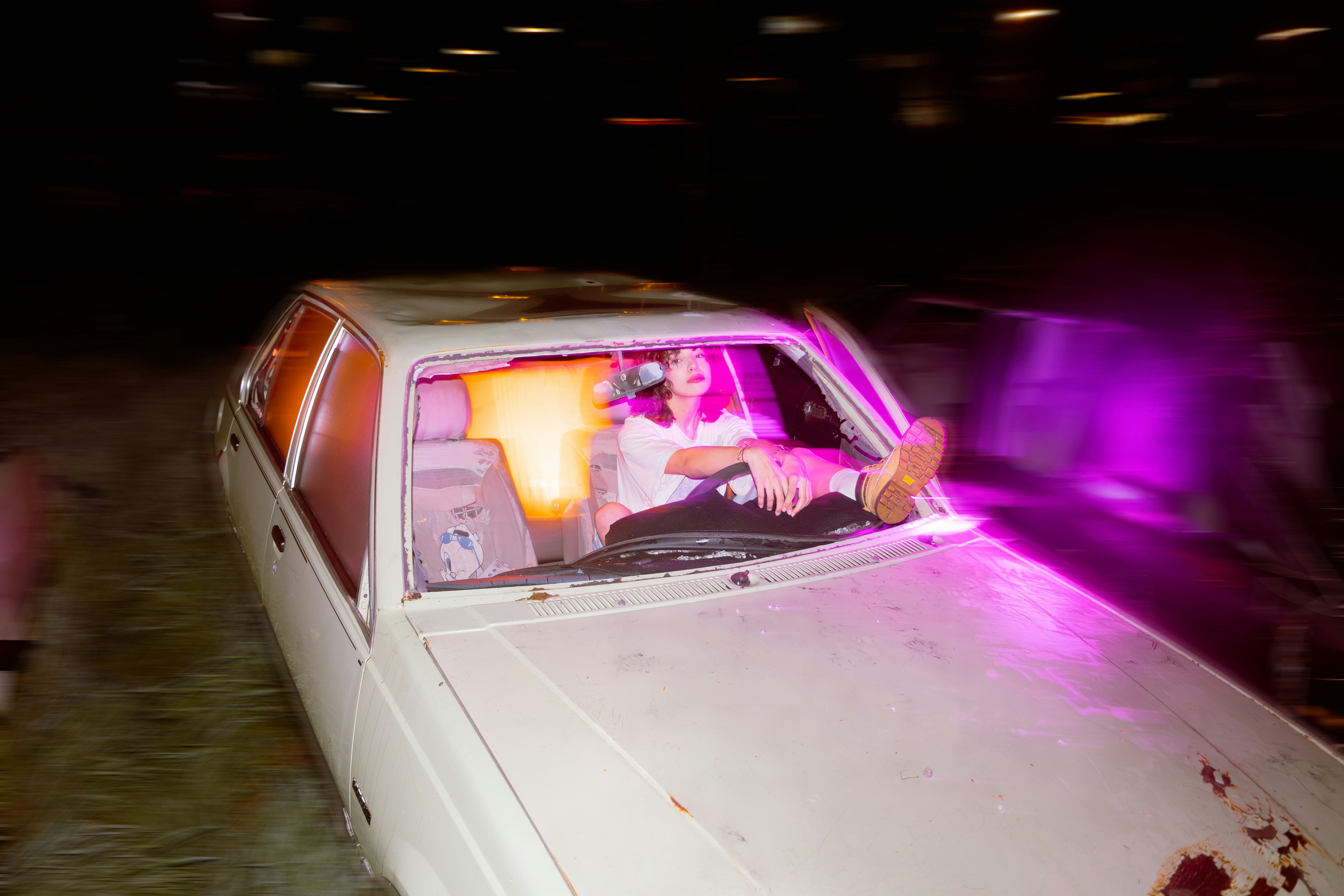 Woman rests in a car with her feet up.