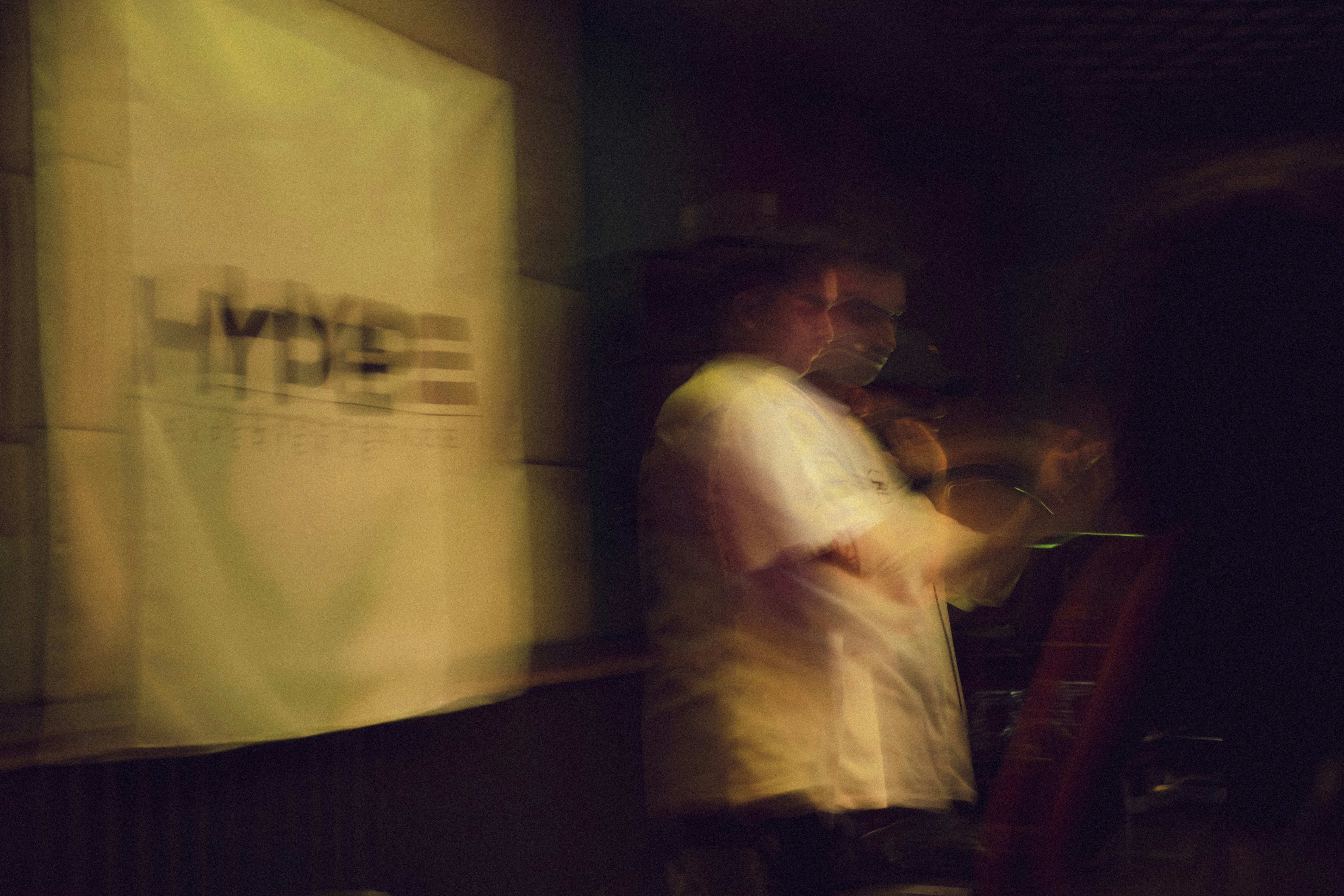 A person is standing near a banner.