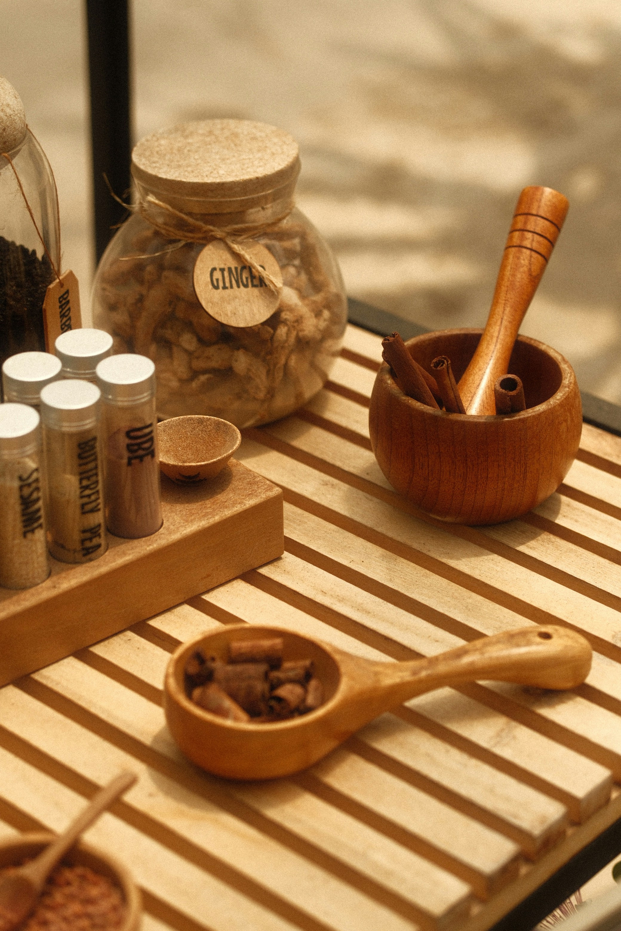 Spices are arranged on a wooden surface.
