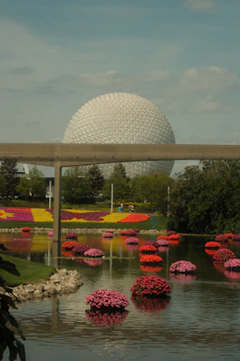 Epcot center's spaceship earth with floating flowers.