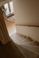 Staircase descends, leading to a bright, curved landing.