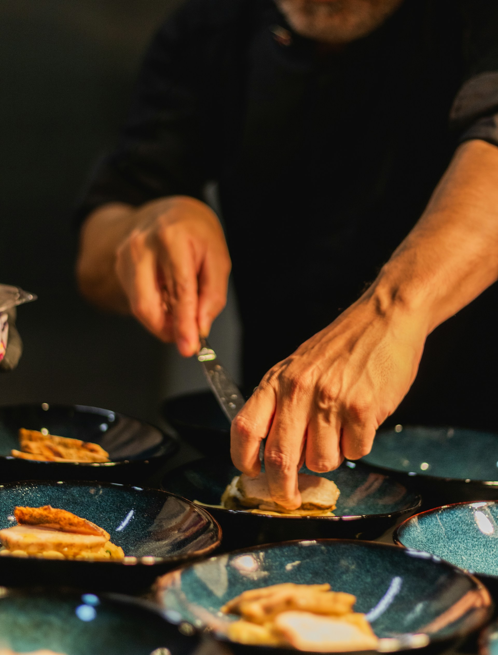 Chef carefully prepares plates for serving.
