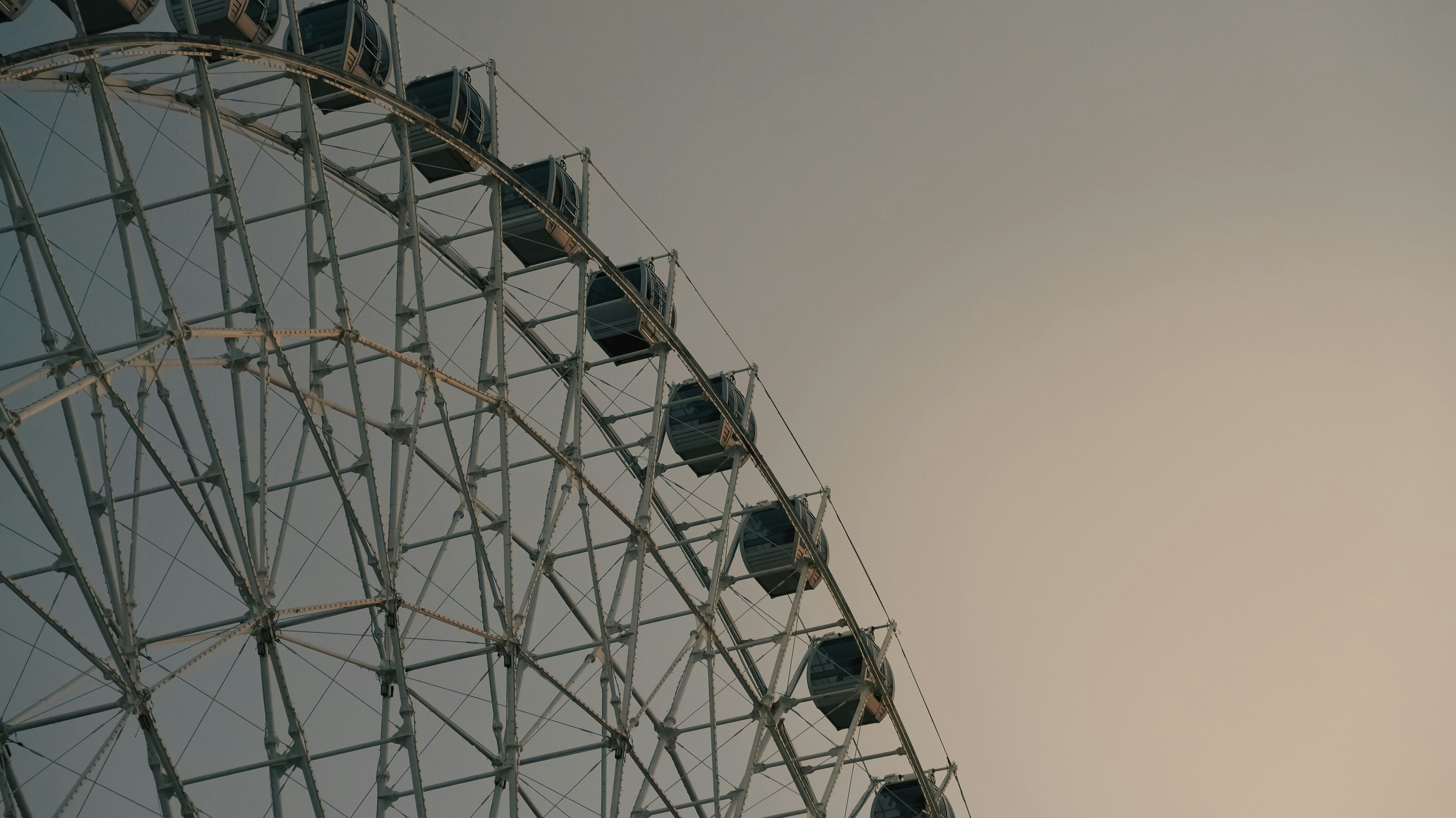 A ferris wheel against a cloudy, gray sky.