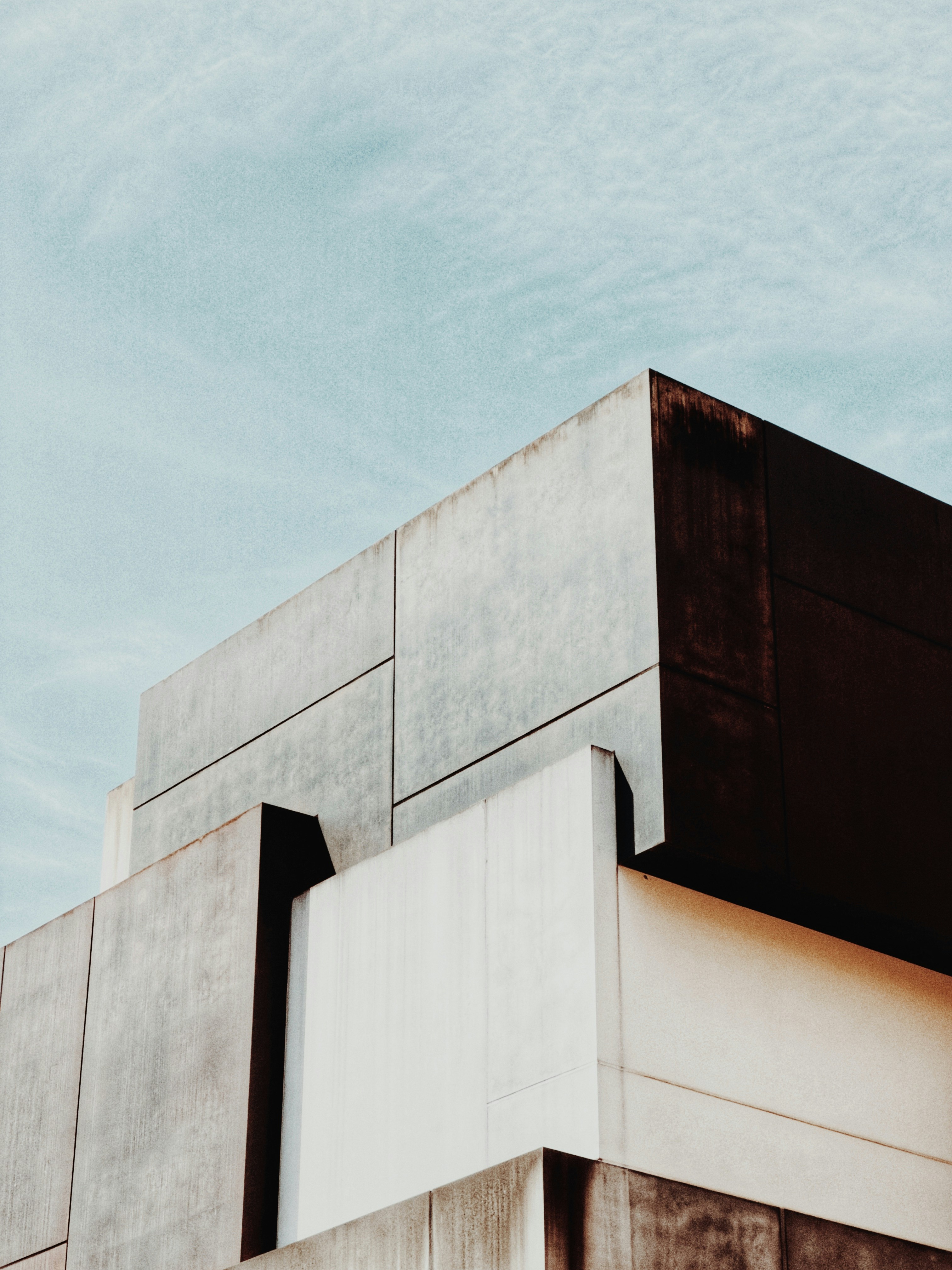 Architectural geometric shapes against a cloudy sky.