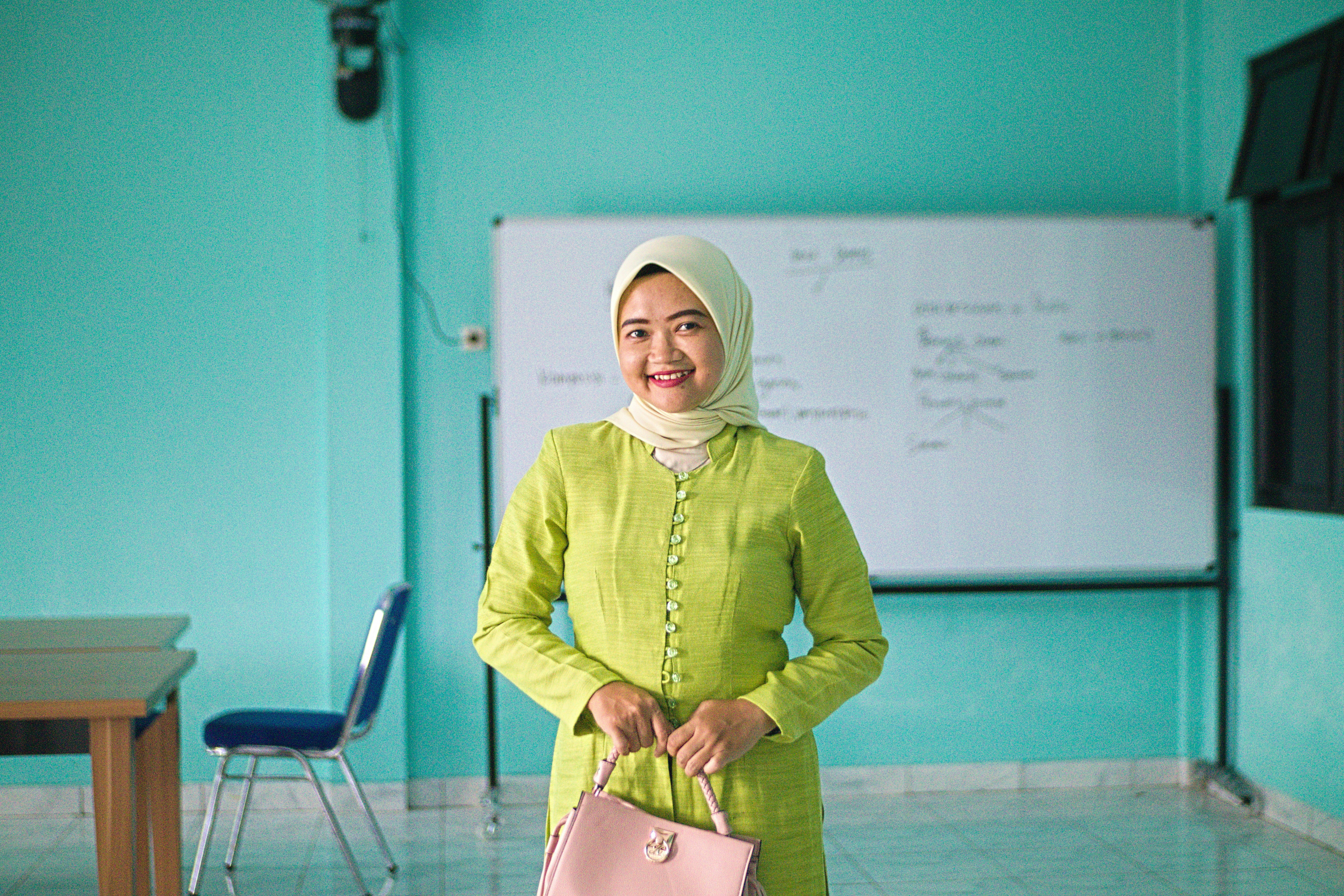 Belitung, Indonesia, on June 06, 2025: Beautiful woman in hijab wearing green kebaya for Kartini event