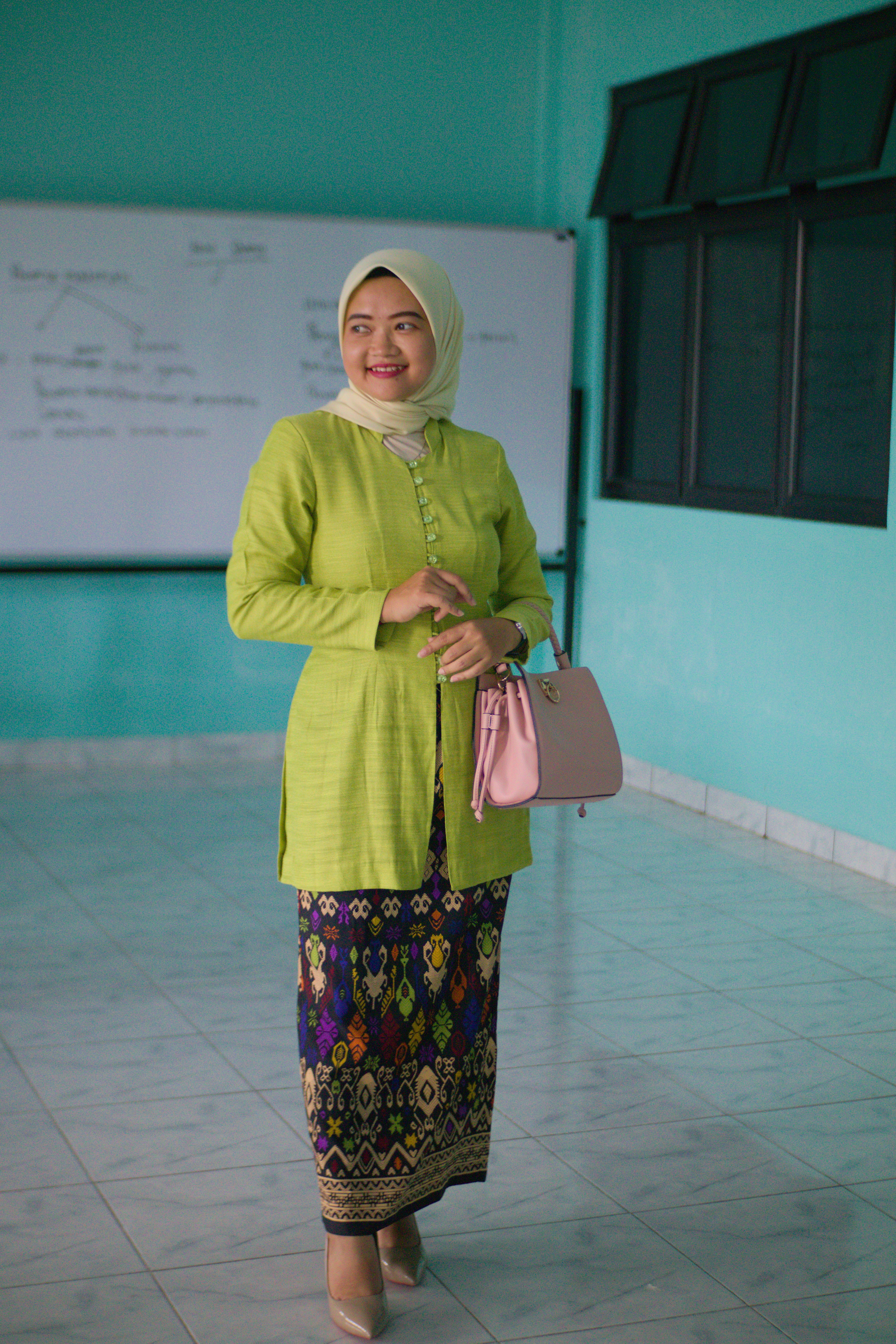 Belitung, Indonesia, on June 06, 2025: Beautiful woman in hijab wearing green kebaya