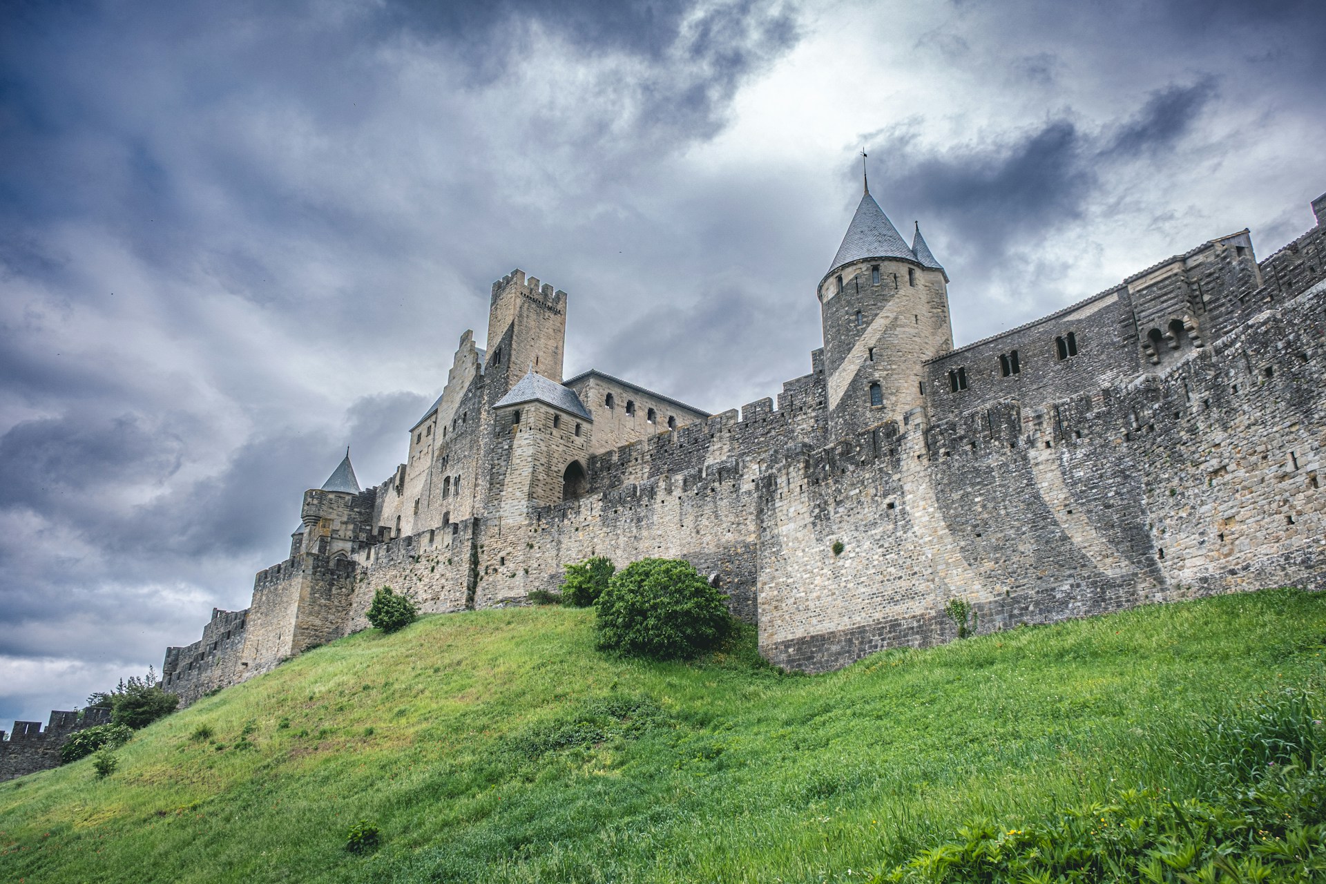 An imposing castle stands against a cloudy sky.