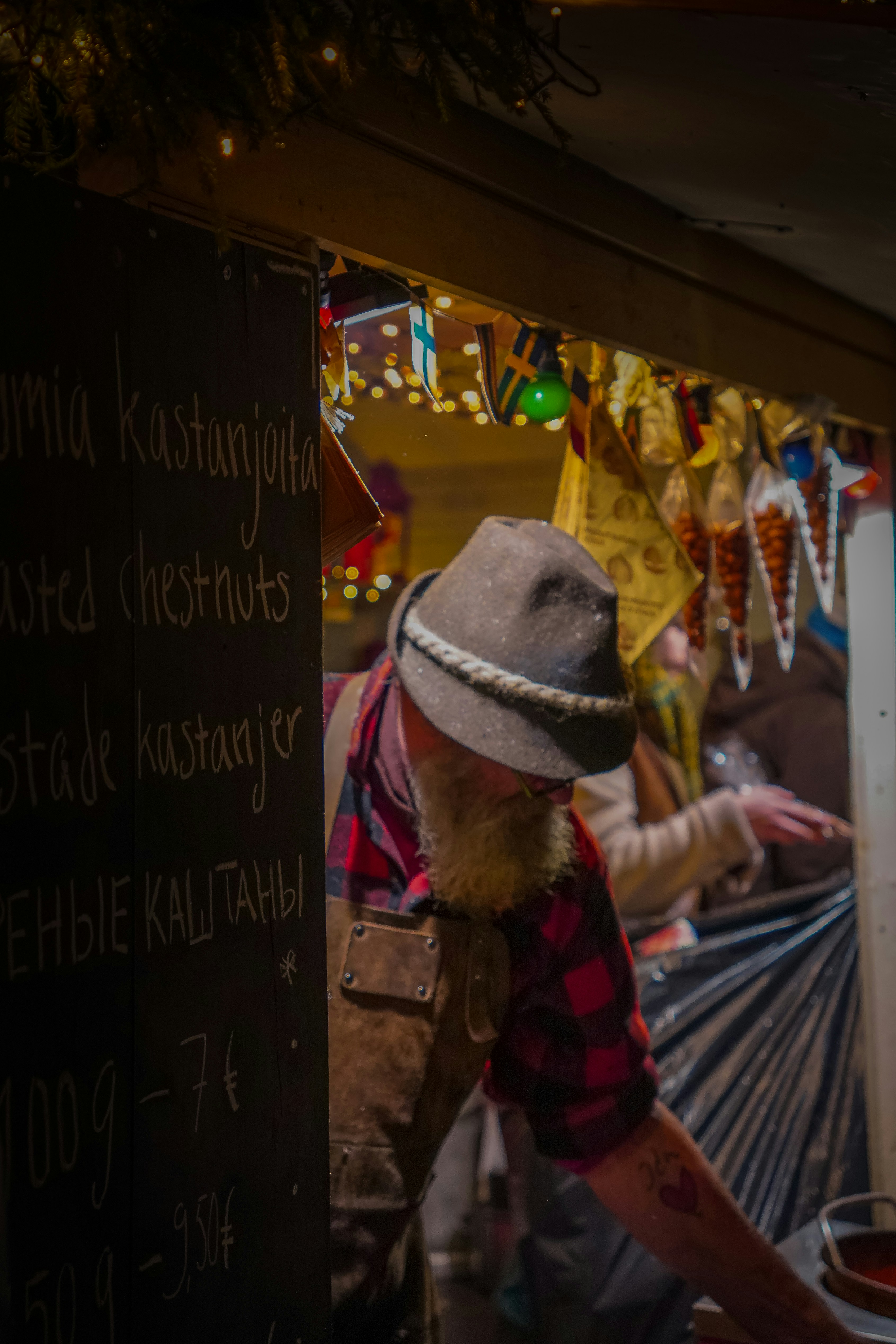A vendor selling roasted chestnuts at a market.