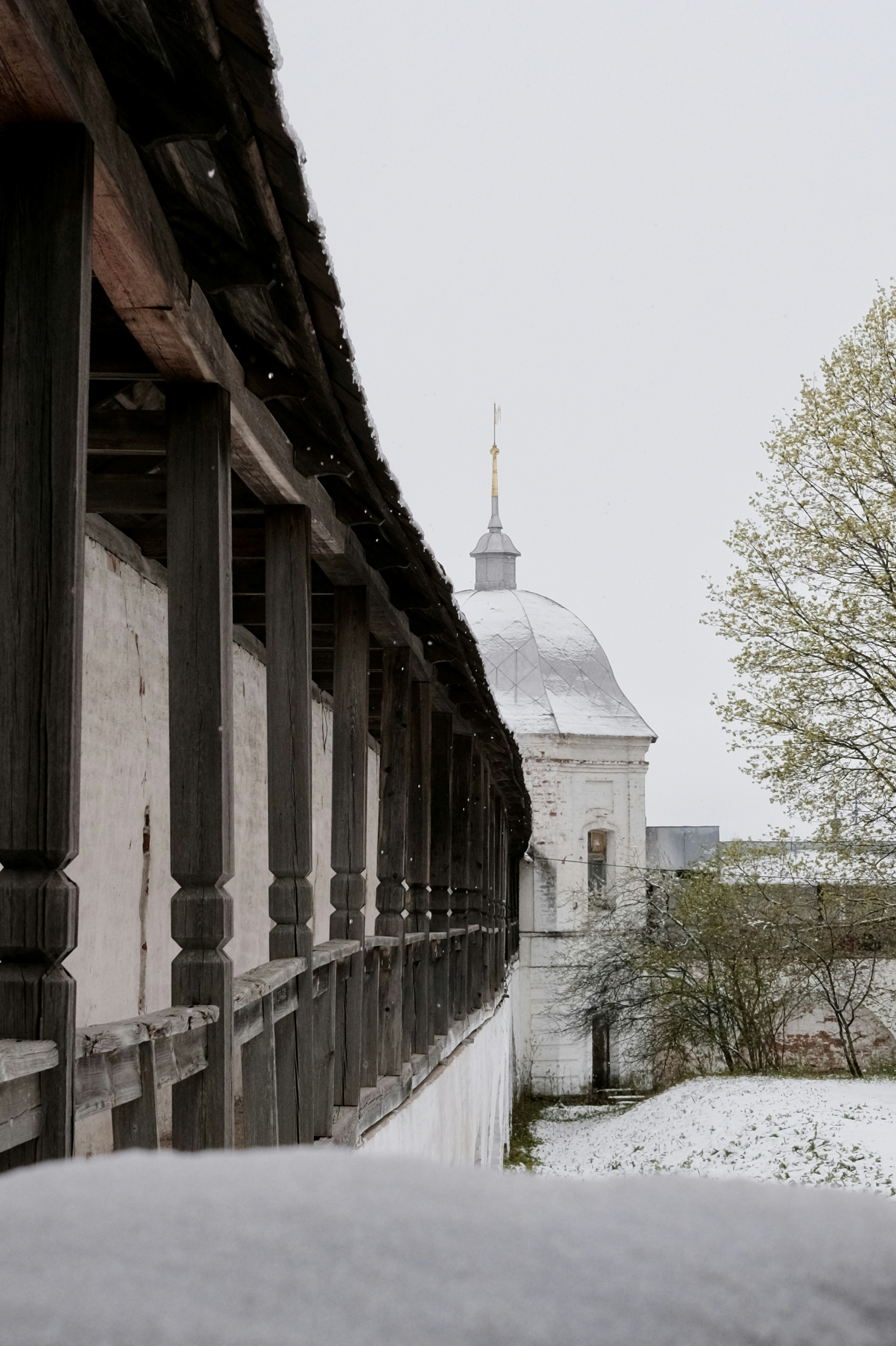 An old wooden walkway leads to a turret.