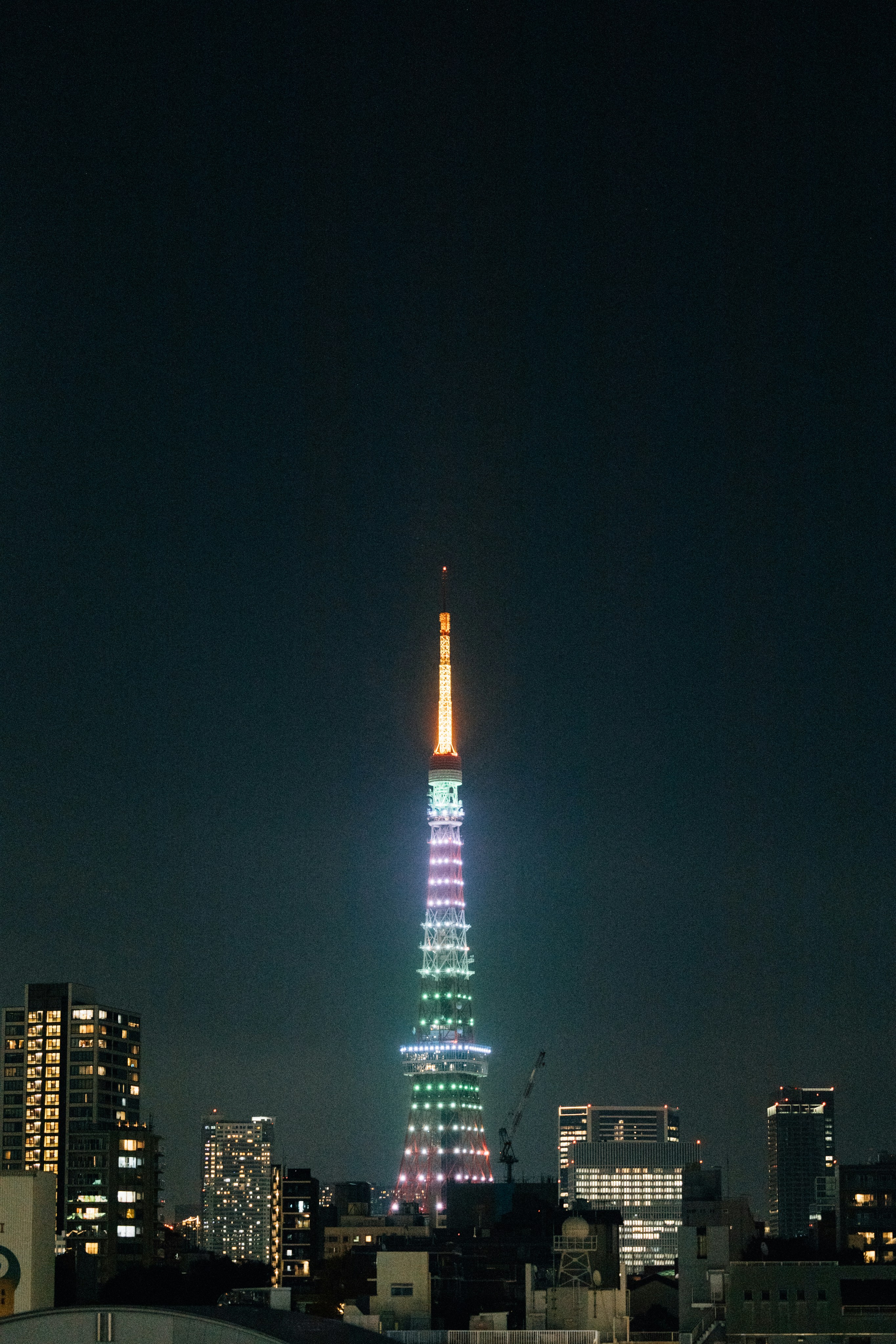 Tokyo tower glows brightly at night.