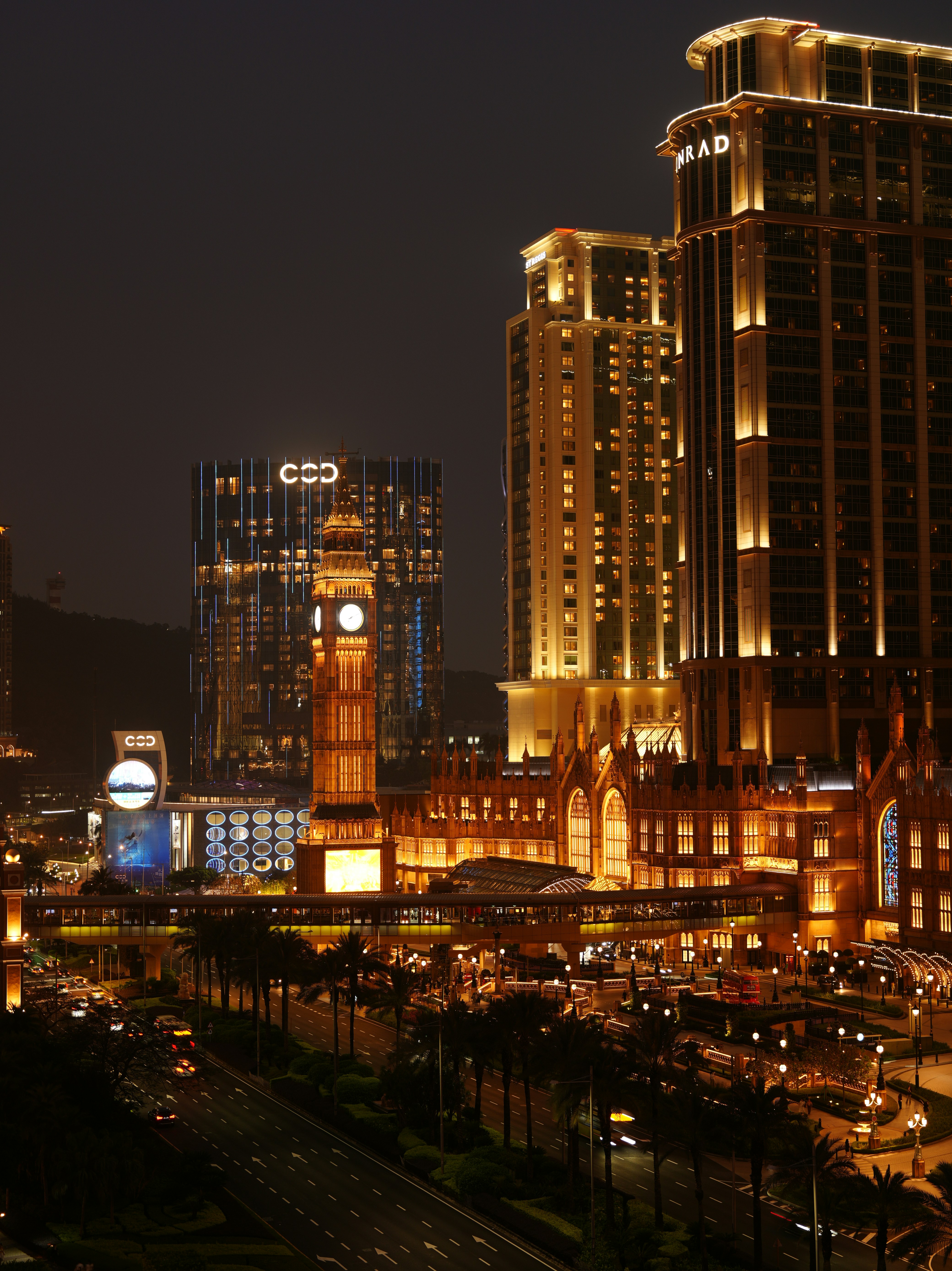 Night view of a cityscape with illuminated buildings.