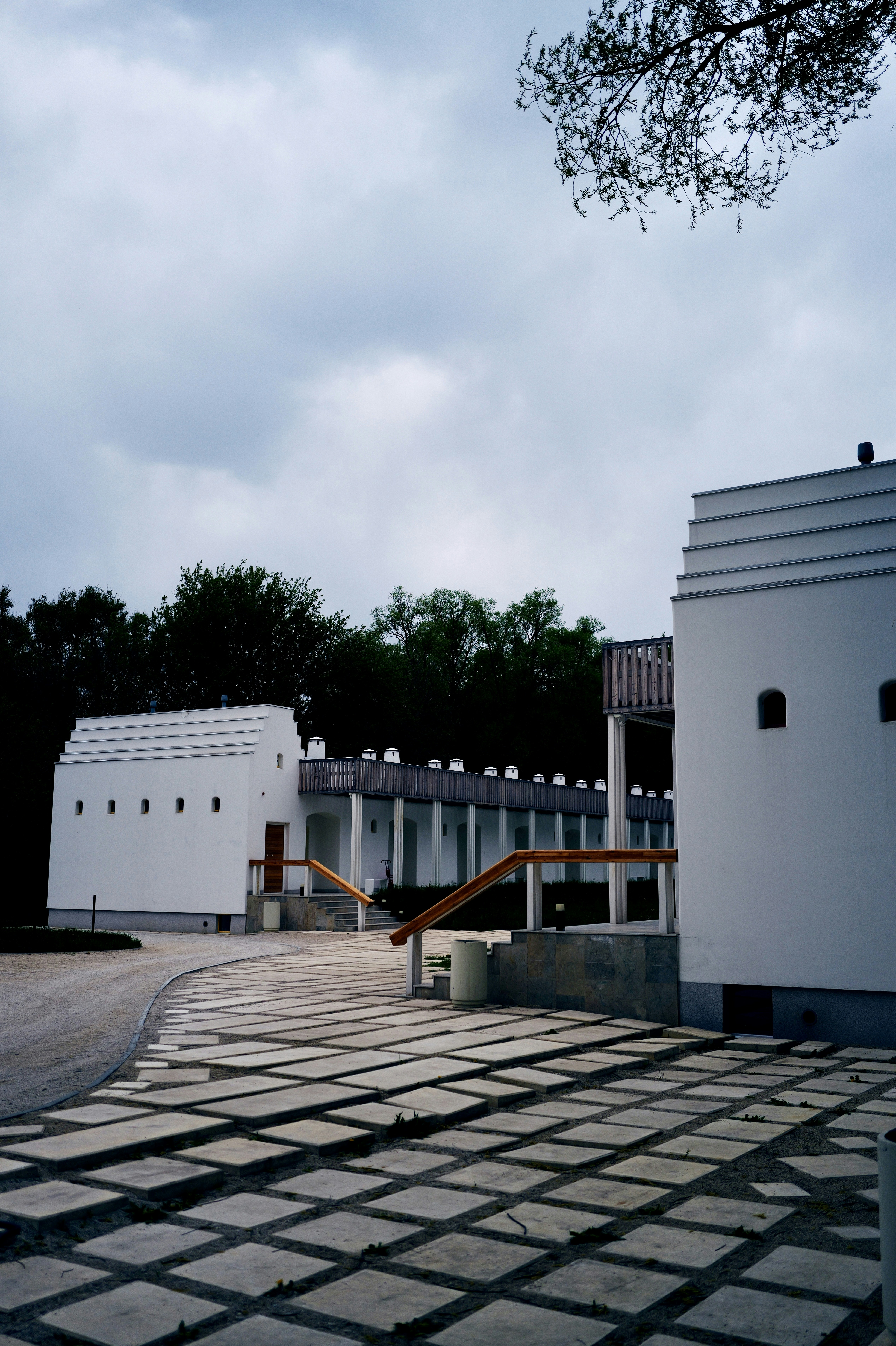 White buildings stand under a cloudy sky.