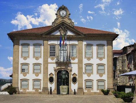 A beautiful, ornate building with a clock on top, sécurisation des mairie et agent de terrain.