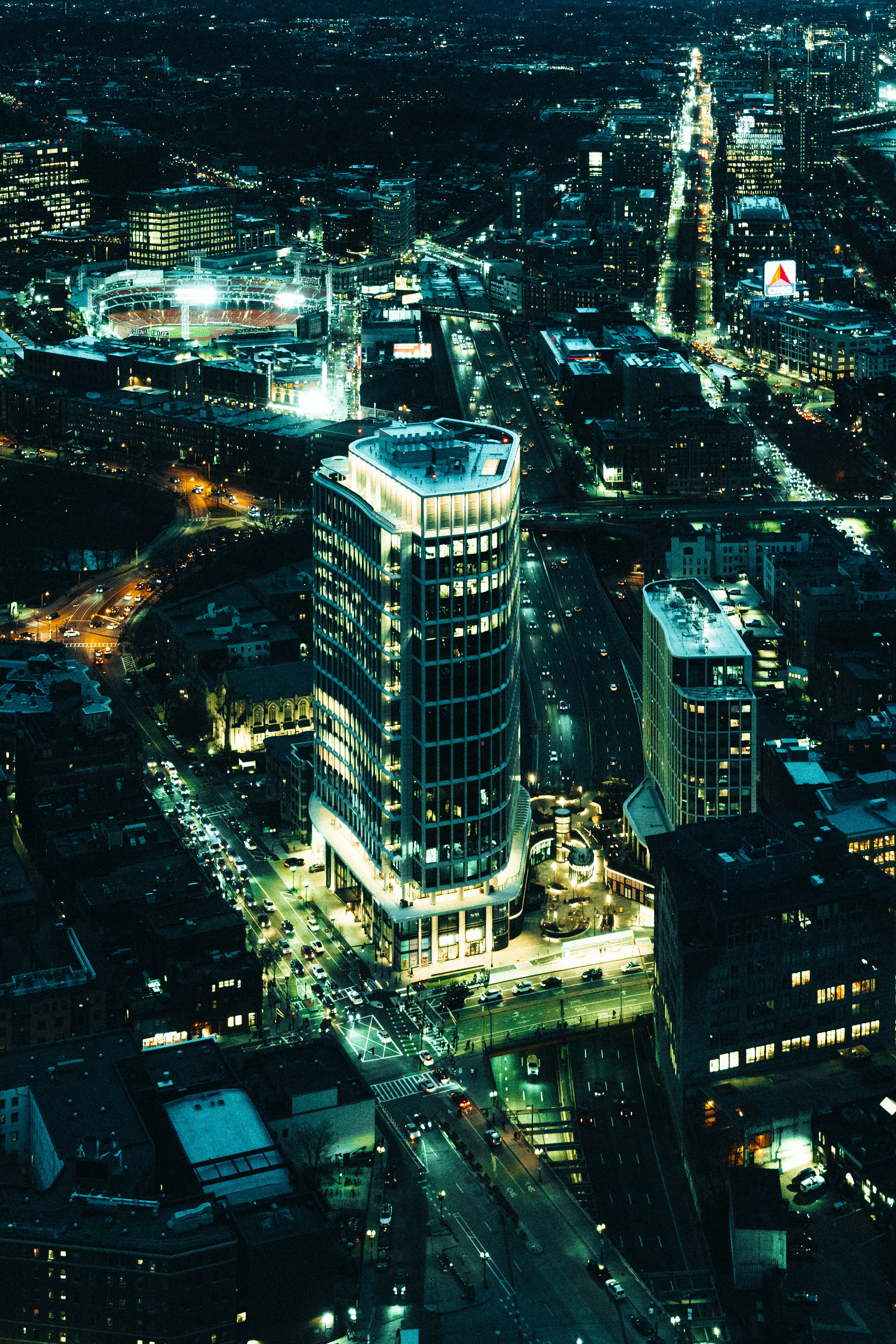 Nighttime aerial view of a brightly lit cityscape.