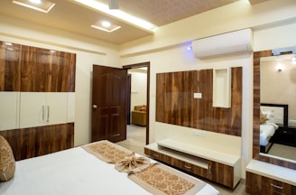 A modern bedroom with wooden accents is shown.
