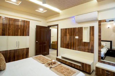A modern bedroom with wooden accents is shown.