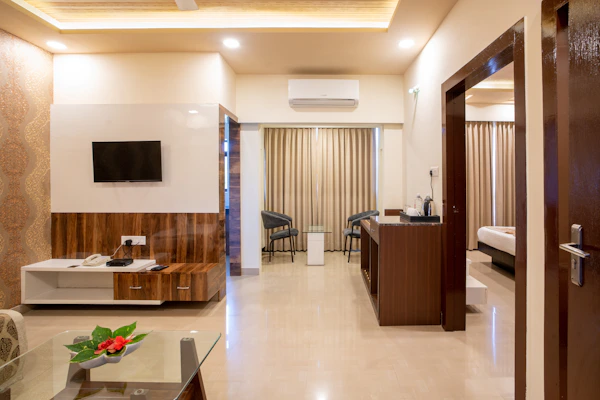 Modern hotel suite with elegant furnishings and a separate living area