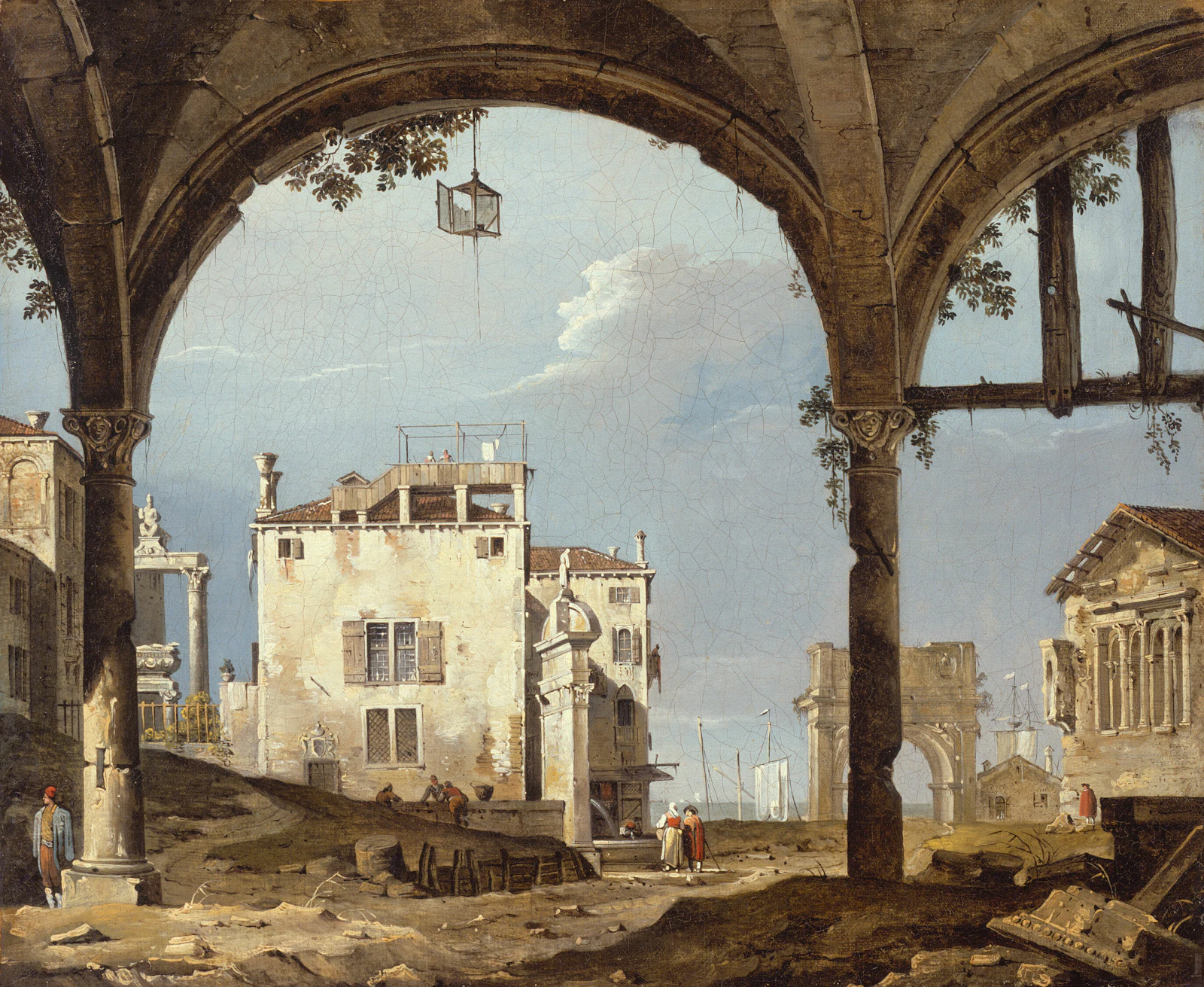 Arched ruins overlook a pale building and distant cityscape