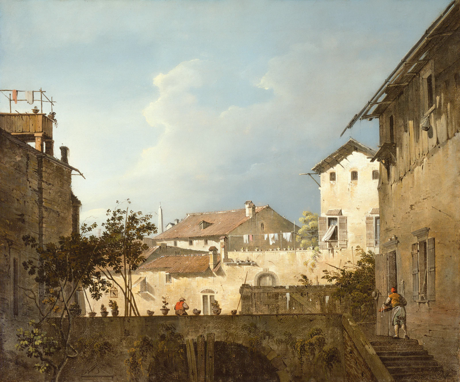 Buildings and a bridge under a cloudy sky
