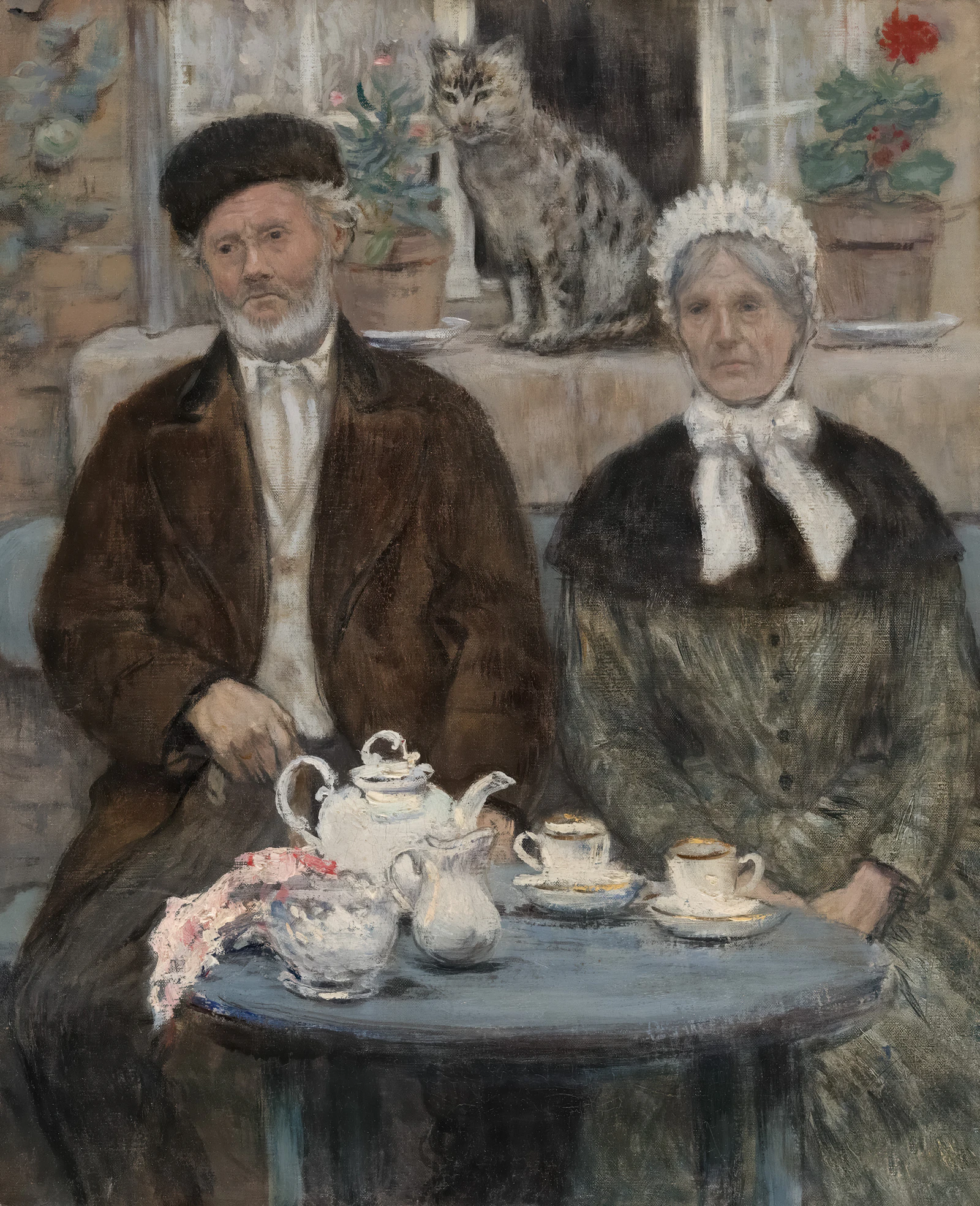 Elderly couple with cat and tea set