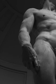 A marble statue of a muscular male.