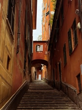 Narrow alley with colorful buildings and stairs.
